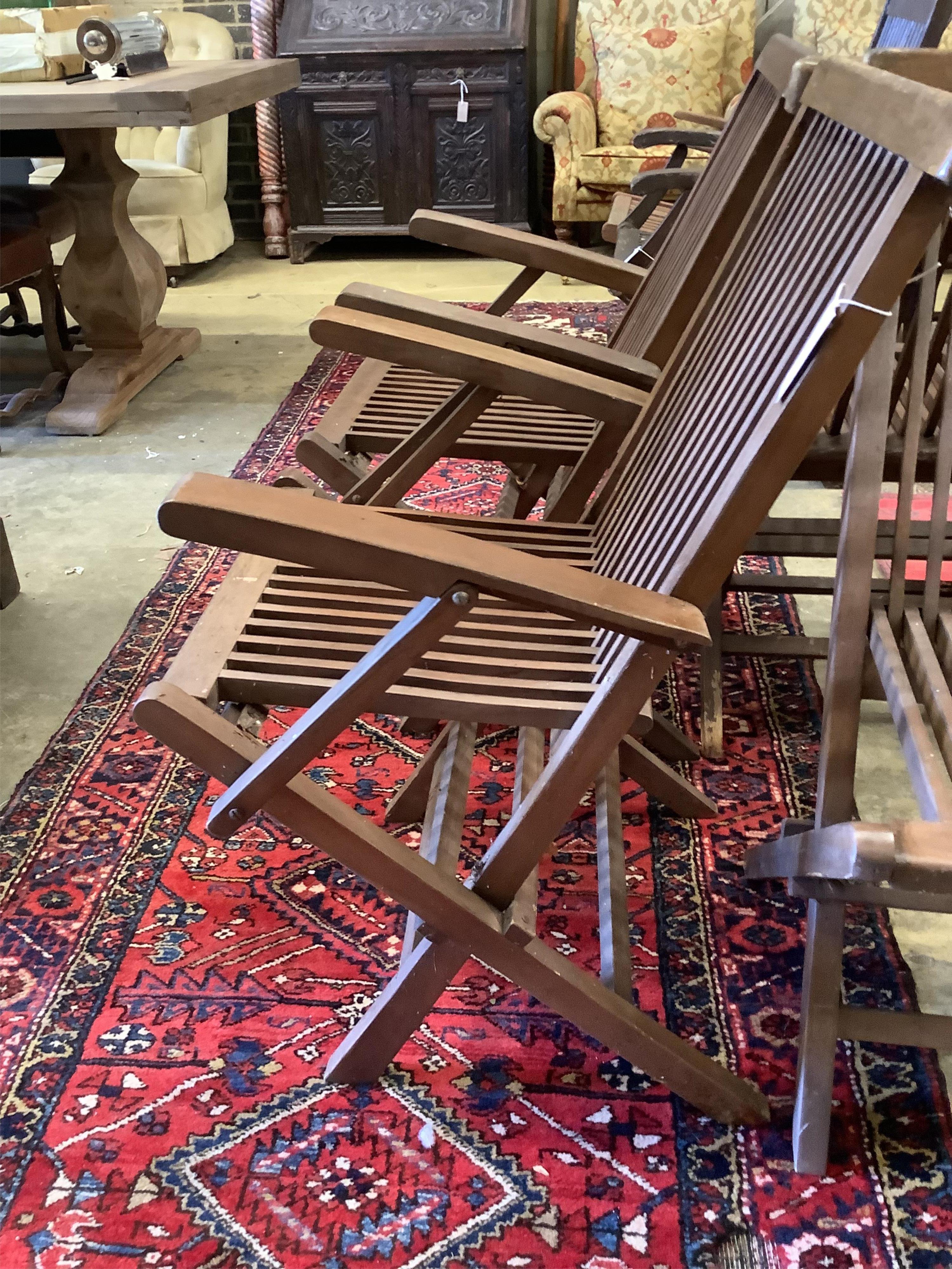 A set of eight teak folding garden chairs (two with arms)